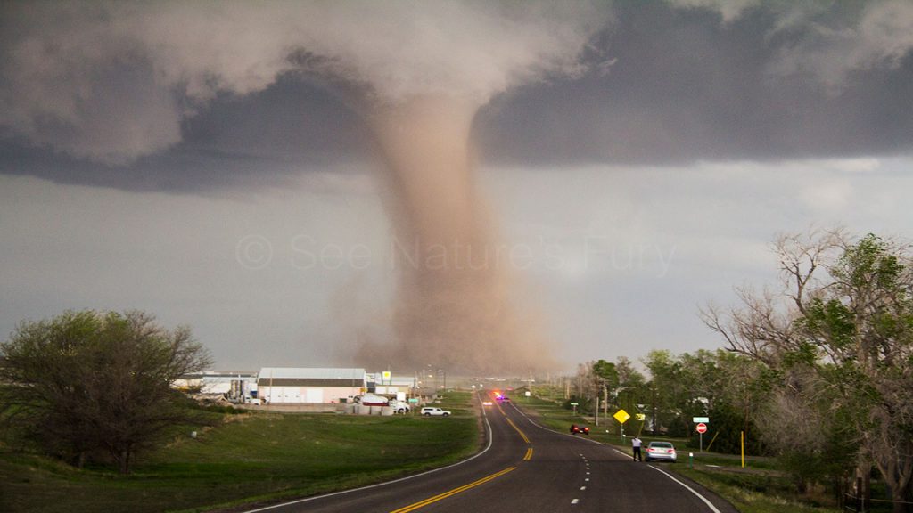 Photogenic tornado that crossed the road. This was shot during a storm chasing and photography tour.