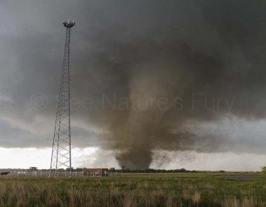 A violent EF4 tornado near Katie Oklahoma tears up the land. Debris is being thrown around. This was shot during a storm chasing, weather and photography tour.
