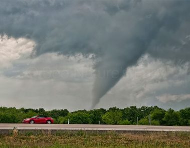 A beautiful cone tornado shows itself after punching through the core of the storm. This was shot during a storm chasing, weather and photography tour.