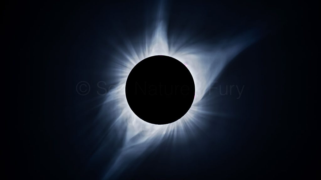 Total solar eclipse of the sun. Solar flares are clearly visible. This was shot during a storm chasing, weather and photography tour.